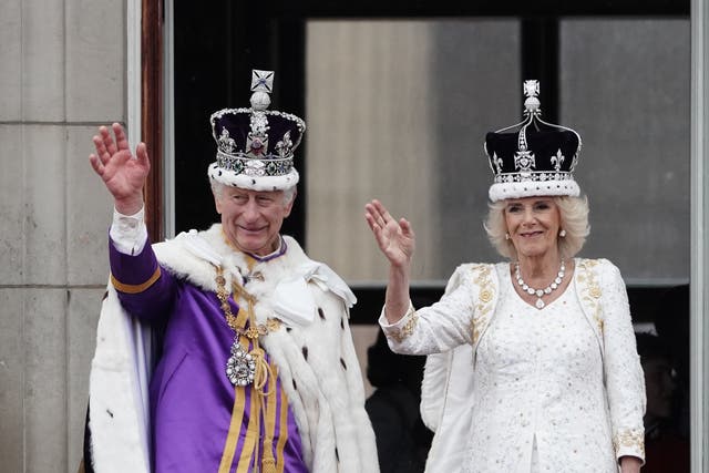 <p>Crowning glory: King Charles III and Queen Camilla wave from the Buckingham Palace balcony after the coronation on 6 May</p>